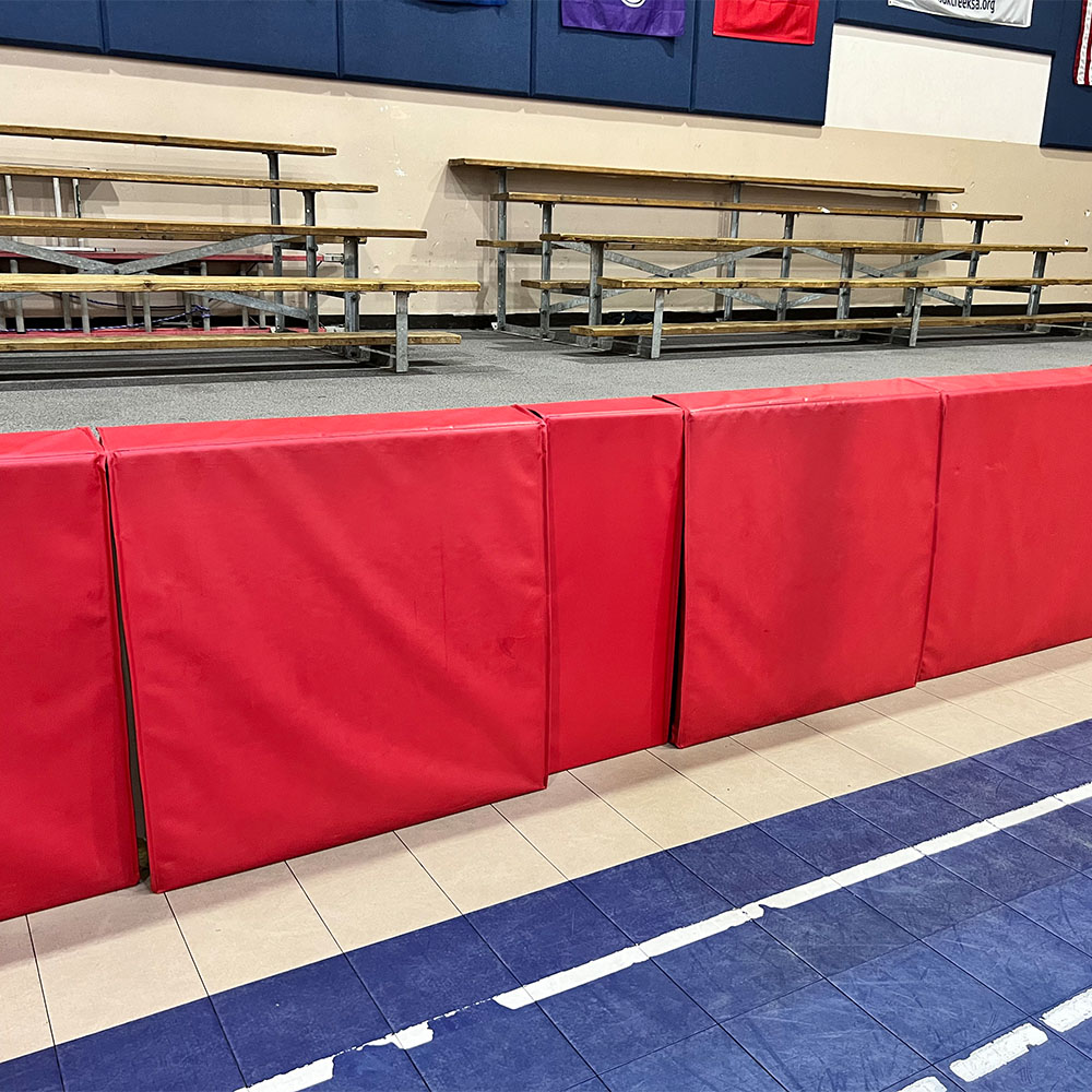 red stage pads used in school gym fastened with velcro
