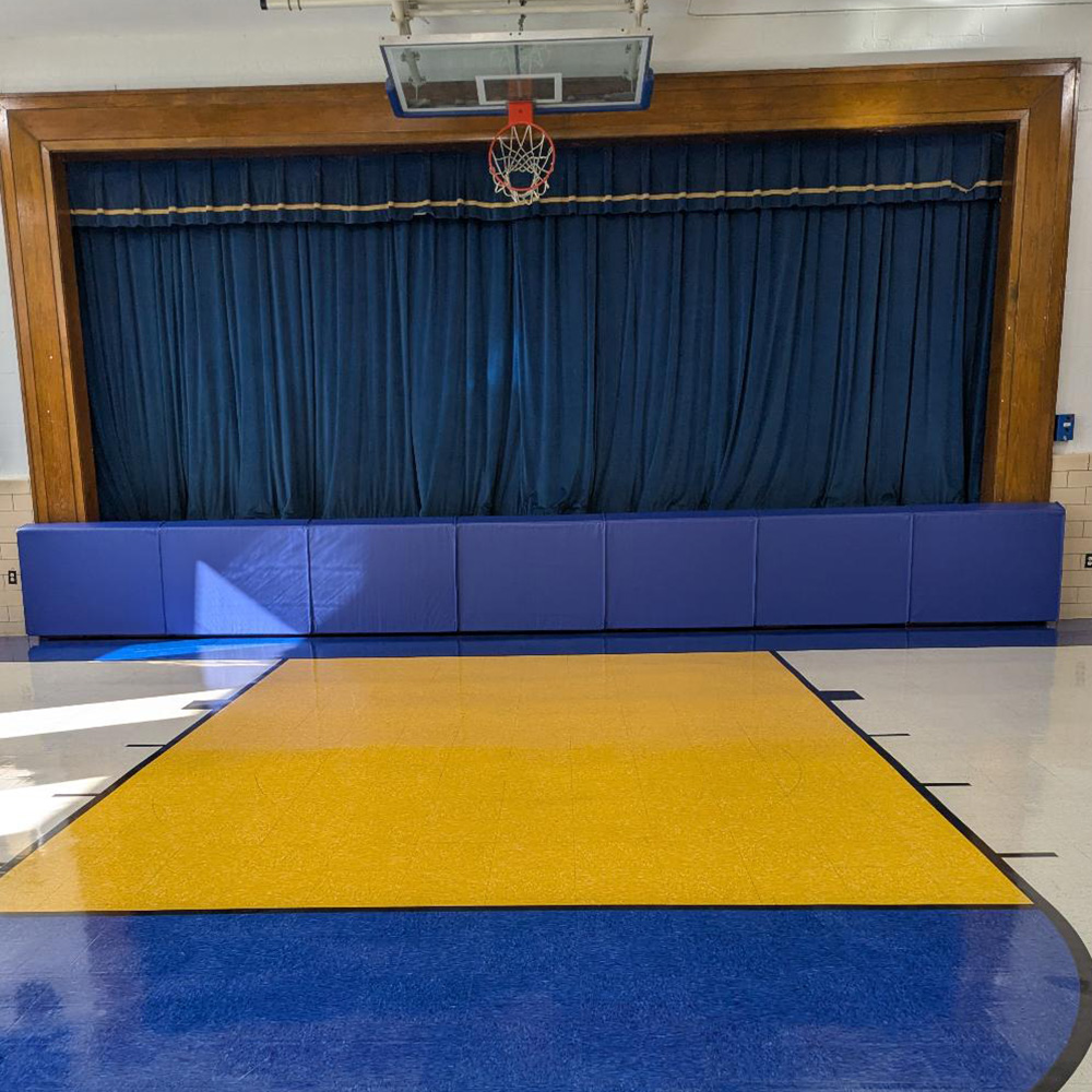 blue stage mats in auditorium gymnasium