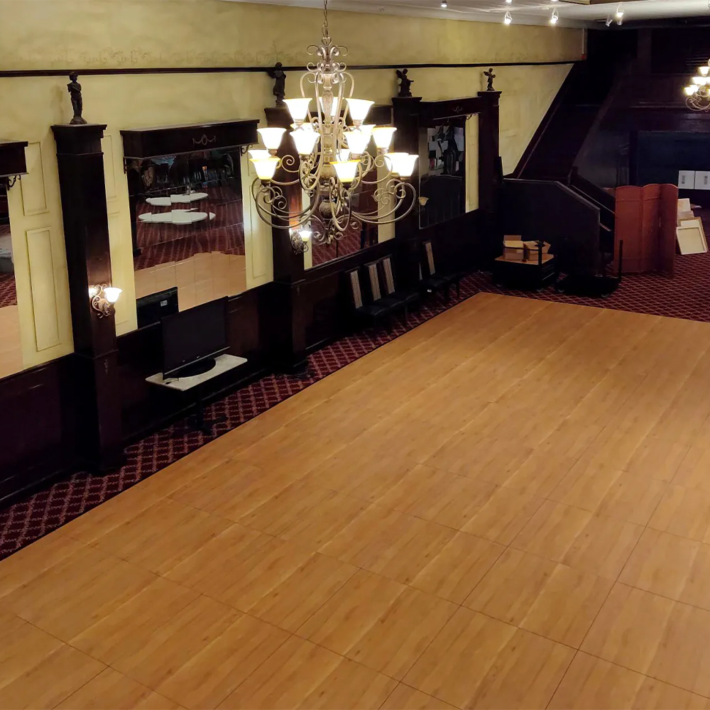 SnapLock Dance Floor Plus Standard Tiles 1/2 Inch x 3x3 Ft. Maple tiles in event room with Chandelier
