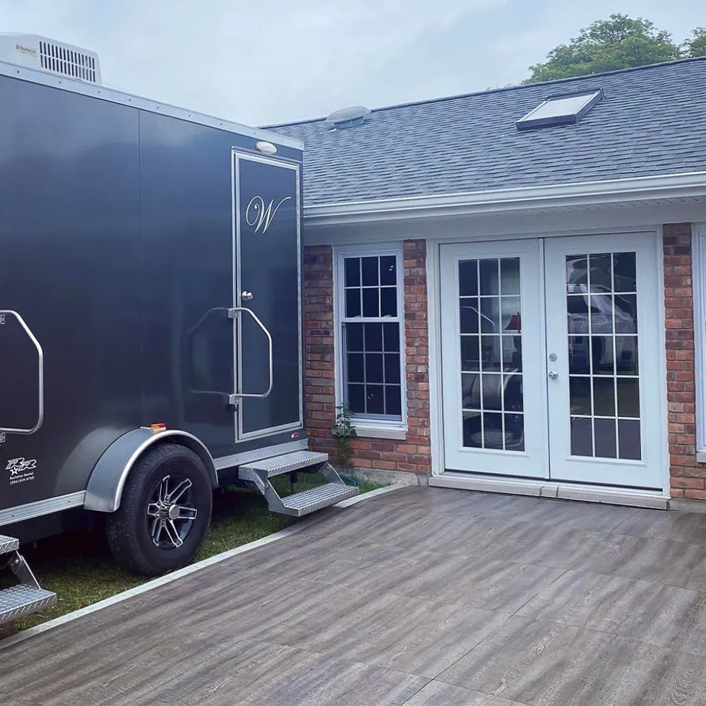 SnapLock Dance Floor Plus Premium Tiles 1/2 Inch x 3x3 Ft. in Smoked Oak next to trailer