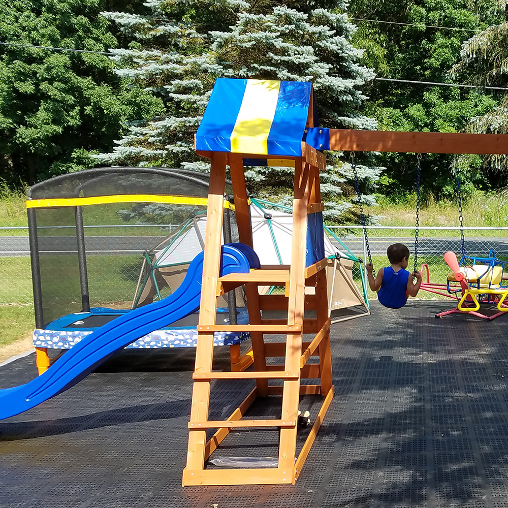 flexible outdoor tiles over uneven ground under swingset