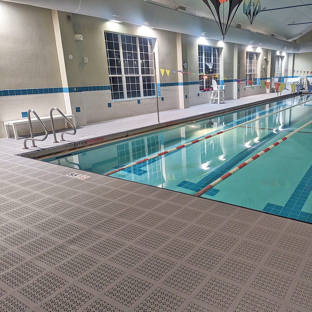 staylock perforated gray tiles installed on indoor pool deck in hotel