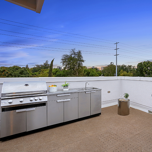tan rooftop tiles on rooftop deck with outdoor kitchen set up