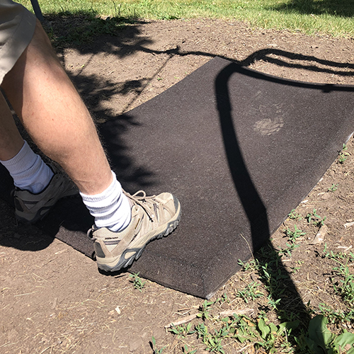 commercial brown playground rubber swing mats underneath swing on dirt