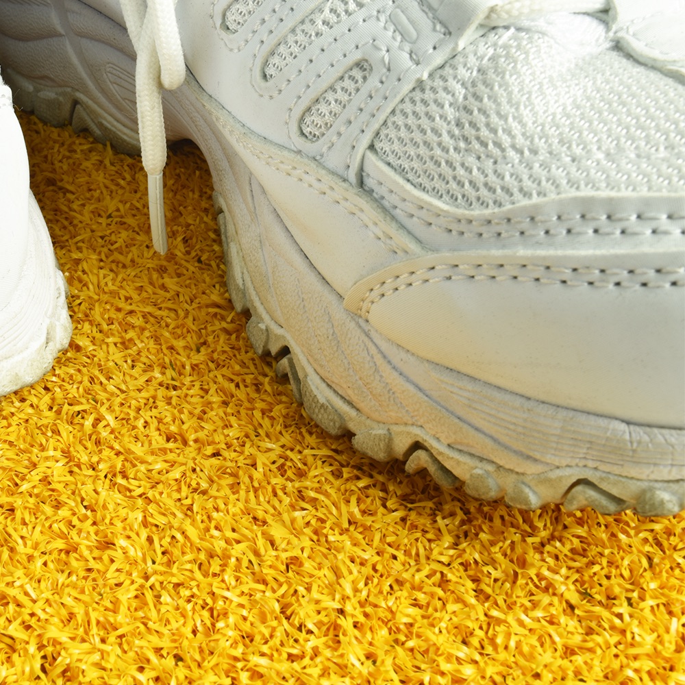 Greatmats Gym Turf Value 3/4 Inch x 15 Ft. Wide 5 mm Foam - Yellow turf White shoes