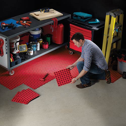 TechFloor Standard with Raised Squares Floor Tile being installed in workshop