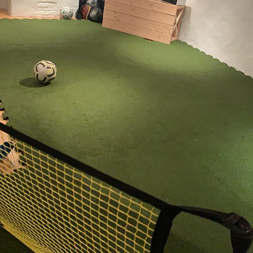 modular turf tiles in basement for soccer practice
