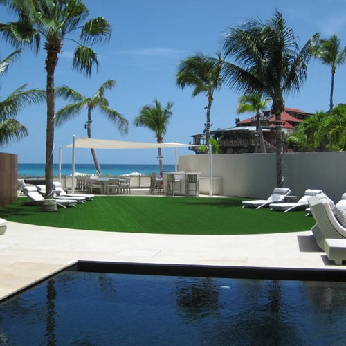 artificial grass next to outdoor pool on beach