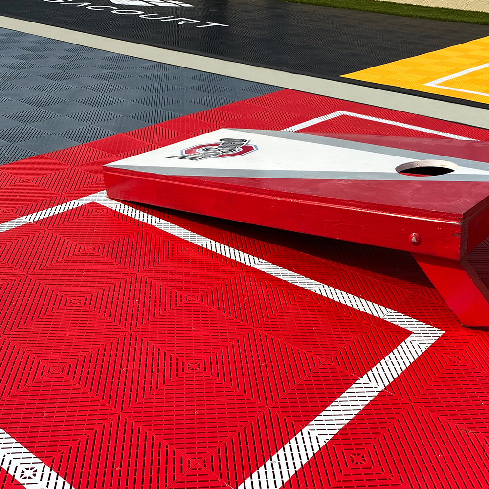 VersaCourt Active Outdoor Court Tile 5/8 Inch 15.75x15.75 Inches cornhole board on bright red tiles