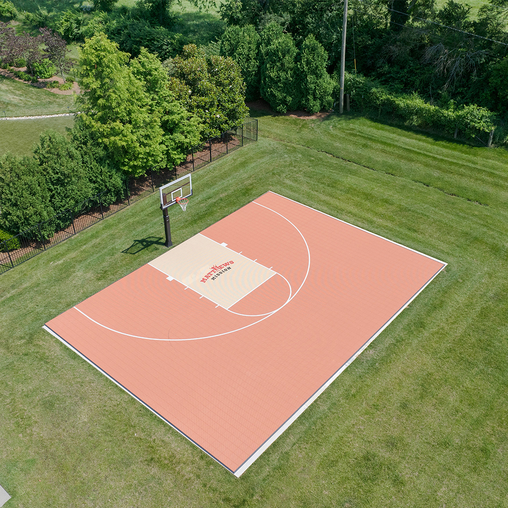 Lay basketball court tiles over grass 