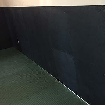 black floor tiles for padding on sheet rock wall