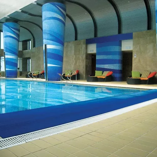 blue pool mat installed around indoor pool at hotel