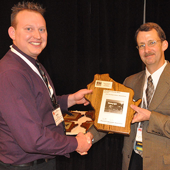 Brett Hart receiving journalism award for Wisconsin Newspaper Association President Andrew Johnson