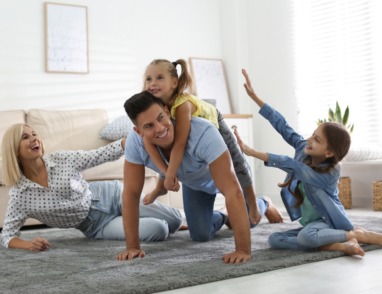 Family playing together on a soft area rug in a living room