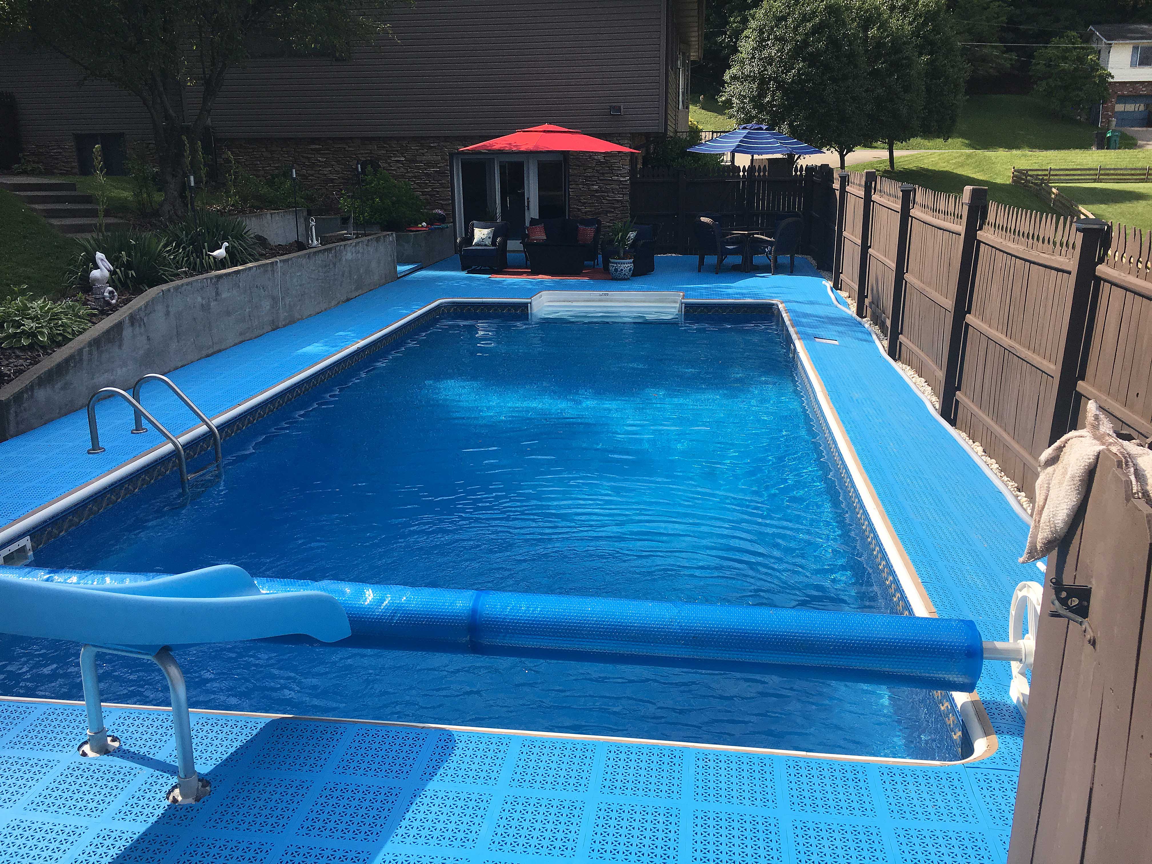 Low cost swimming pool deck surface