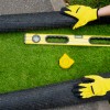 installing artificial grass turf with tools thumbnail