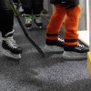 Players entering ice onto Blade Rolled Rubber 9 mm x 4 Ft. Wide Per SF in Zebra