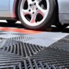 car parked on perforated click together garage floor tiles