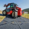 tractor with rubber tires on a ground protection mats