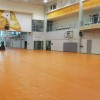 tan Gym Floor Cover 27 oz installed in empty gymnasium