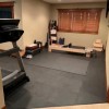 interlocking flooring mats in home gym with exercise equipment