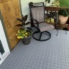 gray outdoor tiles installed over wood deck
