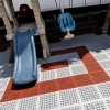 budget friendly playground flooring tiles over top of  patio pavers thumbnail