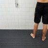 person standing in pool shower room on heronrib matting