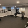 basement home gym with rolled rubber flooring