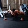 Man Doing Pushups on Rolled Rubber Flooring