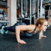 Woman planking on rubber flooring rolls with 10 percent color