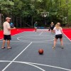 DunkStar BaseCourt Outdoor Tile with Lines 30x60 Ft. bright red and graphite with family playing pickleball