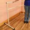 Portable Ballet Dance Barre 6 Ft. with person standing next to barre