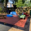 StayLock Perforated Black outdoor tiles over dirt black border play area