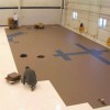 people installing tuff-seal floor tiles in aircraft hangar