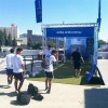 portable flexturf gym turf roll at outdoor trade show with people kicking soccer balls