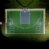 VersaCourt Boost Outdoor Court Tile 1/2 Inch x 1x1 Ft.in emerald greena and graphite aerial view with lights