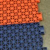 VersaCourt Outdoor Game Court Tile 3/4 Inch x 10x10 Inches close up of two tiles interlocked over concrete