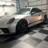 Coin Top PVC tiles in black and gray checkerboard pattern in garage with porsche