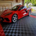 black and red perforated garage tiles under red car