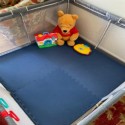 blue kids foam mats on floor in playpen