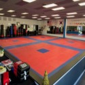 martial arts studio with red and blue grappling mma mats