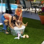 kids washing dog over turf mat thumbnail