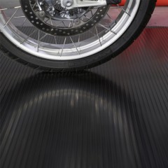 Motorcycle park on G-Floor Ribbed Tread Vinyl Multipurpose Roll 1.4 mm x 5x10 Ft. in midnight black