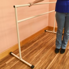 Portable Ballet Dance Barre 6 Ft. with person standing next to barre
