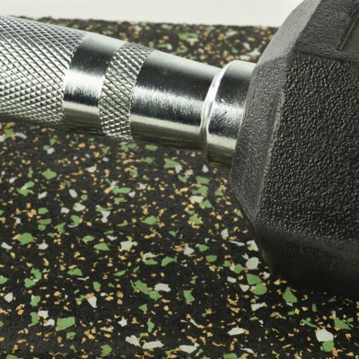 close up of dumbbell on flexecork rubber cork tiles with green color flecks