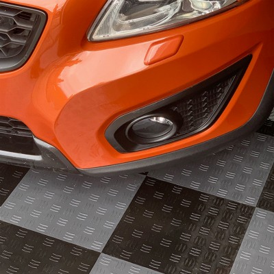 black and gray garage floor tiles diamond pattern with orange car