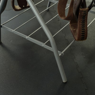 12x14 foot interlocking horse stall mat kit installed in tack room with saddle rack