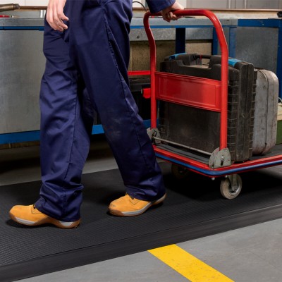 person with cart walking on Firmagrip Industrial Matting in industrial facility