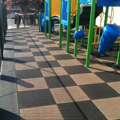 Playground flooring rubber tiles installation at a park.